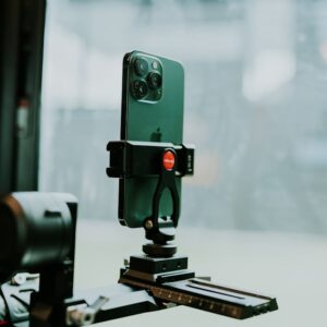 A modern smartphone mounted on a tripod indoors, perfect for tech setups.